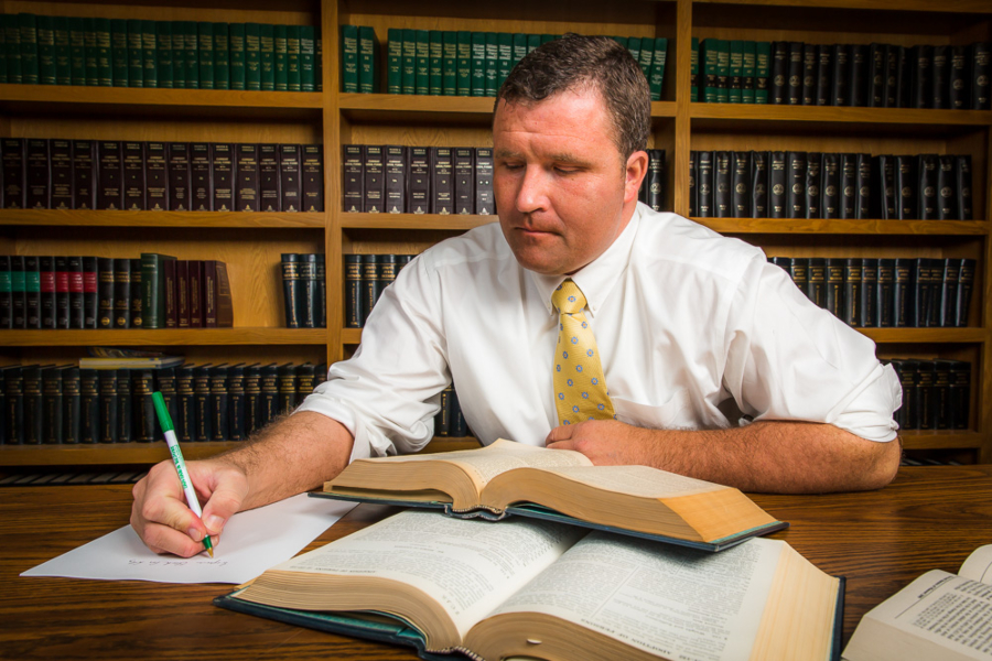 Ben Winfrey taking notes from a legal book